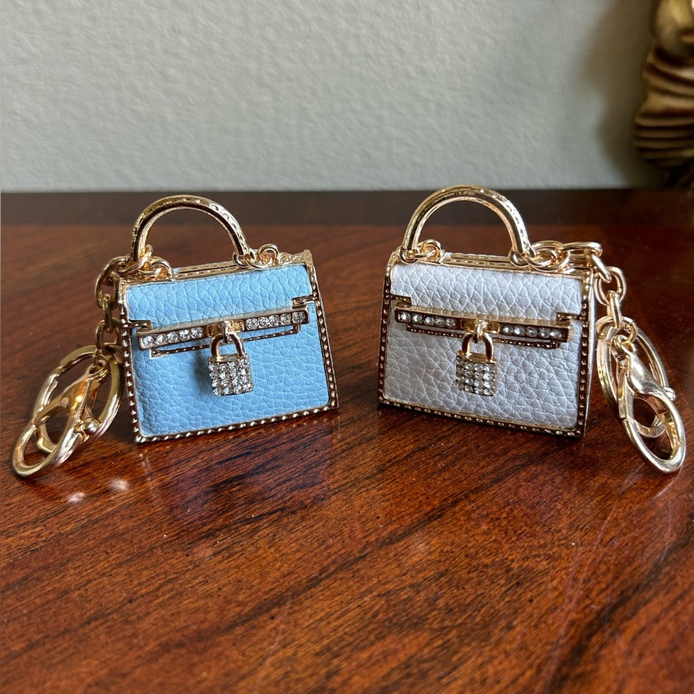 Bundle of 2 key chain / purse fobs in blue and white metal